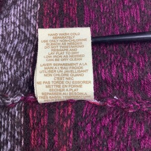May include: A tan fabric care label with instructions for washing, bleaching, drying, ironing, and dry cleaning. The text is in both English and French.