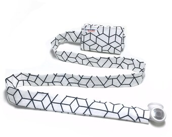 White and black abstract TuneTube.  Earbud cord organizer for iPhone or iPod.  Cord keeper.  Earbud holder.  Earbud case.