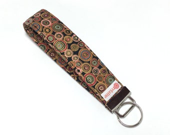 Gold circles keychain, key fob, key wristlet, key holder, key chain.  Colorful gold circles on black.  Fabric keychain wristlet.