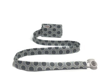 TuneTube earbud cord organizer for iPhone or iPod.  Cord keeper. Earbud holder. Earbud case.  Gray circles.