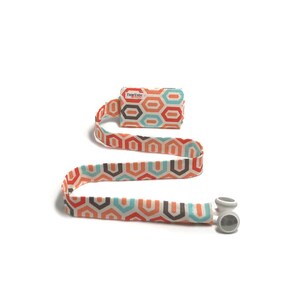 May include: A white, orange, teal, and brown patterned fabric lanyard with a small white rectangle attached to the top. The rectangle has the text "TummyTube" printed on it.