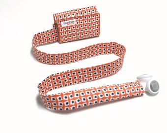 Orange with dots and squares TuneTube.  Earbud cord organizer for iPhone or iPod.  Cord keeper.  Earbud holder.  Earbud case.