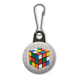 May include: A colorful Rubik's Cube design on a white button with a black and silver zipper pull.