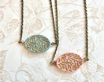 Gold etched pendant necklace in pink or blue