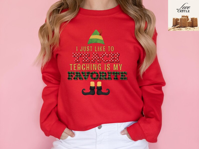 May include: A red sweatshirt with the text "I JUST LIKE TO TEACH TEACHING IS MY FAVORITE" in a festive design. The design includes an elf hat, polka dots, and plaid patterns, with elf shoes at the bottom. A fun, teacher-themed apparel item.