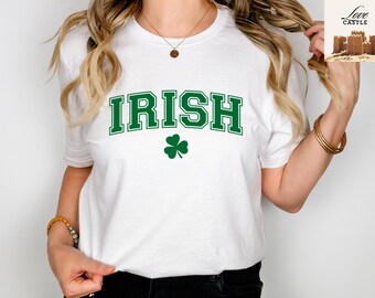 May include: White t-shirt with green text that says "IRISH" and a green shamrock.