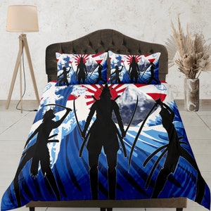May include: A blue, red and white duvet cover with a Japanese wave pattern and silhouettes of samurai warriors holding swords. The duvet cover features a rising sun and a mountain.