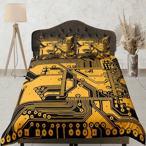May include: A yellow and black duvet cover with a circuit board pattern. The duvet cover is on a bed with two matching pillowcases.