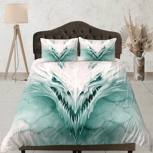 May include: White duvet cover with a green dragon face design. The dragon's face is centered on the duvet cover and has a menacing expression.