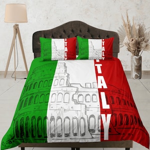 May include: A white, green and red bedding set featuring a drawing of the Colosseum and the word "ITALY" printed on it. The bedding set includes a duvet cover and two pillowcases.