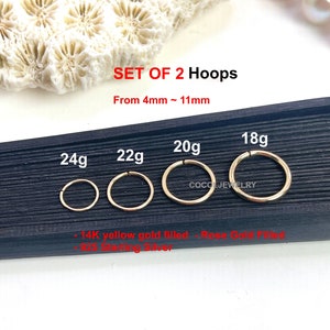 May include: A set of two gold-colored hoop earrings in various sizes, ranging from 4mm to 11mm. The image displays the earrings with gauges 18g, 20g, 22g, and 24g. The text "SET OF 2 Hoops" is visible.