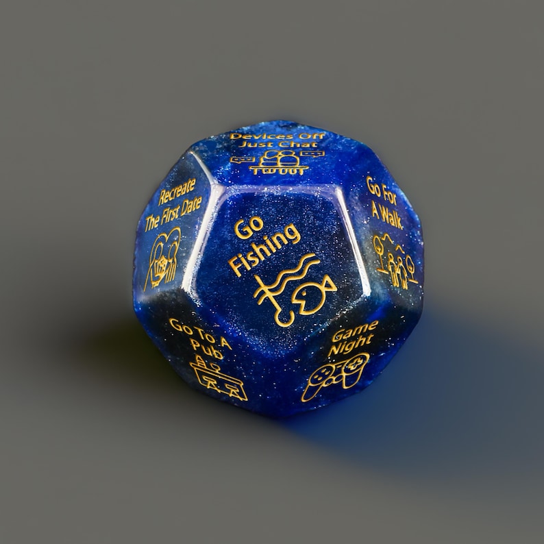 a blue dice with gold writing on it