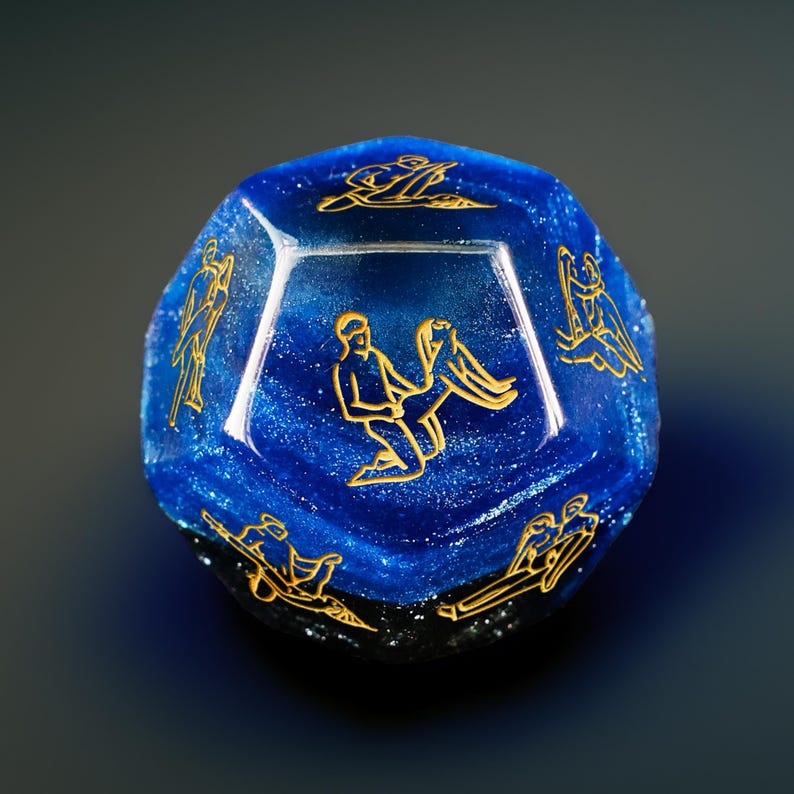 a blue glass object with gold designs on it