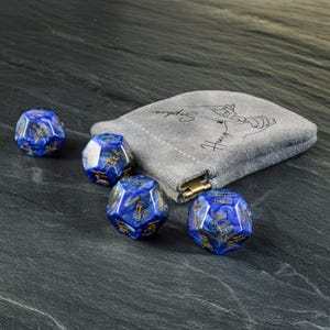 a bag with some blue dices on a table