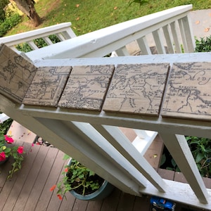 May include: Four square coasters with a vintage map design. The coasters are made of cork and have a brown and white color scheme. The maps on the coasters feature the text "Medjter", "Pontus", "Thrace", and "Africa".