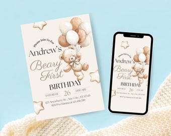 May include: A birthday invitation and a smartphone showing the same design. The invitation features a teddy bear holding balloons, with text that reads "Andrew's Beary First Birthday" and the date. The design includes star accents.