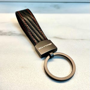 Mercedes-Benz AMG keychain in black, with AMG logo. High-quality Mercedes-Benz AMG keychain. AMG logo.