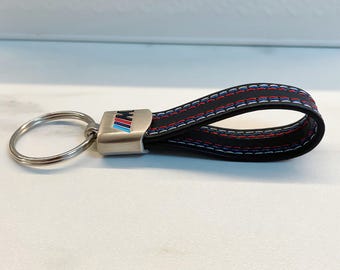 M keychain with M logo and M colors. High-quality M keychain, M logo and M colors.