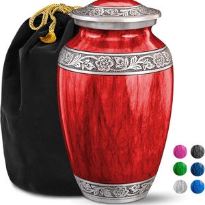 May include: Red and silver cremation urn with a floral design. The urn comes with a black velvet carrying bag.