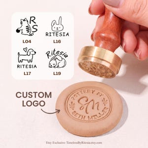 May include: A brass pottery stamp with a wooden handle pressing into a circular clay disc. The clay shows the embossed text Pottery By Seth Miller and the initials SM. A graphic chart displays four logo options labelled L04, L16, L17, and L19.