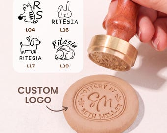 May include: A brass pottery stamp with a wooden handle pressing into a circular clay disc. The clay shows the embossed text Pottery By Seth Miller and the initials SM. A graphic chart displays four logo options labeled L04, L16, L17, and L19.