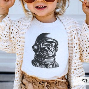 Adorable Space Cat Shirt featuring a cute kitty in an astronaut helmet, perfect for kids outer space birthday celebrations. This galaxy cat shirt makes a great gift for young space enthusiasts
