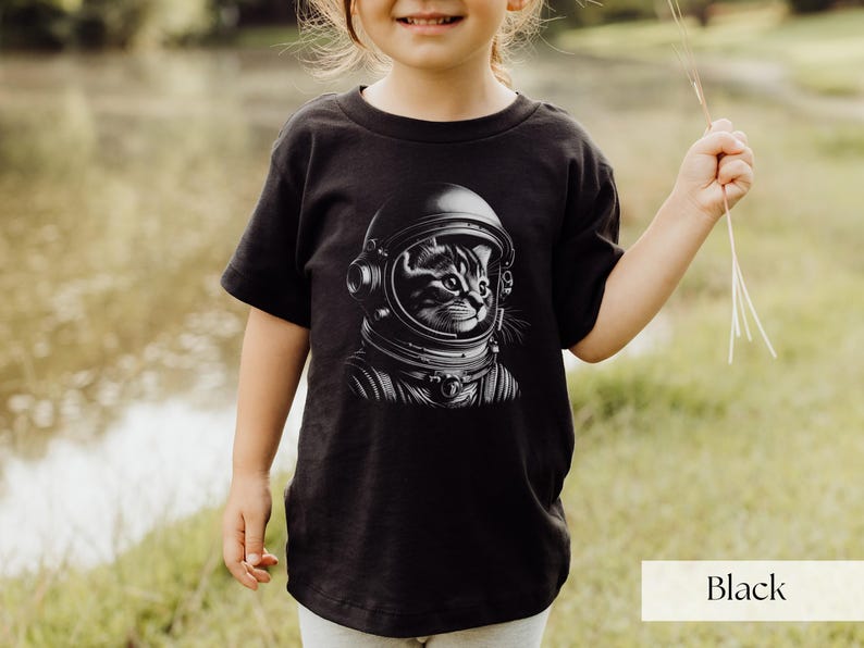 Adorable Space Cat Shirt featuring a cute kitty in an astronaut helmet, perfect for kids outer space birthday celebrations. This galaxy cat shirt makes a great gift for young space enthusiasts