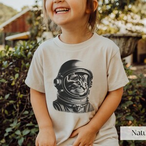 Adorable Space Cat Shirt featuring a cute kitty in an astronaut helmet, perfect for kids outer space birthday celebrations. This galaxy cat shirt makes a great gift for young space enthusiasts