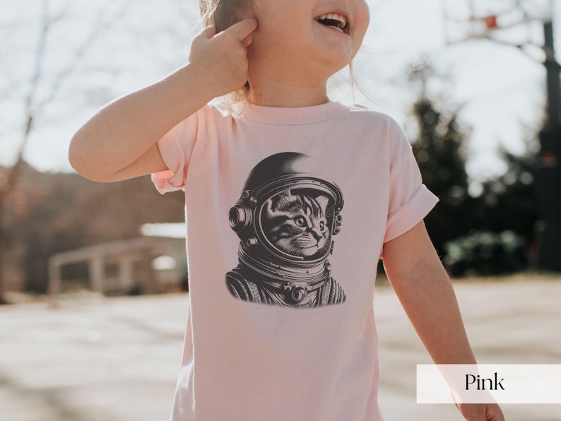 Adorable Space Cat Shirt featuring a cute kitty in an astronaut helmet, perfect for kids outer space birthday celebrations. This galaxy cat shirt makes a great gift for young space enthusiasts