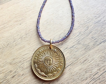 1978 Argentina Gold Sun Coin Necklace, Matte Purple Glass Seed Bead Chain, Solid Brass Clasp, Gift Boxed, Made in USA by E. Ria Designs