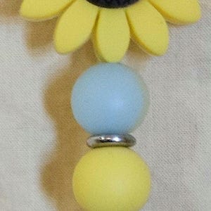 May include: A white ceramic mug with a black handle and the text "But First, Coffee" in a black, bold font. The mug is on a white surface. The mug is likely 11 ounces.