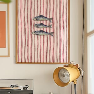 Striped sardines printable wall art displayed in a modern coastal kitchen setting