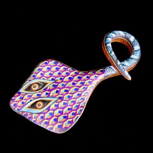 May include: An abstract art piece with a geometric pattern in purple, blue, and yellow. The design includes two stylized eye shapes and a looped handle. The artwork is set against a black background.