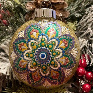 Hand painted 3 inch round metallic green, red, blue and purple “flower” Mandala Christmas ornament