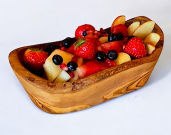 May include: A wooden bowl filled with a colorful fruit salad. The salad includes bright red strawberries, blueberries, and apple slices. The bowl has a natural wood grain finish and is set against a white background.