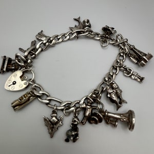 Vintage Sterling silver bracelet with 13 different charms