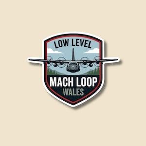 May include: A sticker featuring a stylized illustration of an airplane with the text "LOW LEVEL MACH LOOP WALES". The design is set against a backdrop of a blue sky and green trees, with a red and white border.
