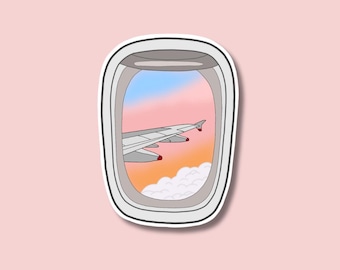 May include: A sticker of an airplane wing seen through an airplane window. The sky outside the window is a pink and blue sunset with clouds.