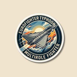 May include: A circular sticker depicting a grey Eurofighter Typhoon multirole fighter jet. The jet is set against a sunset with clouds. The text "EUROFIGHTER TYPHOON MULTIROLE FIGHTER" is printed around the edge.