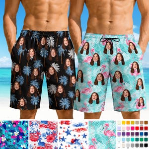 May include: Two pairs of swim trunks featuring custom photo prints. The left pair is black with blue palm trees and repeated faces. The right pair is light blue with pink flamingos and repeated faces. Both have black drawstring waistbands.