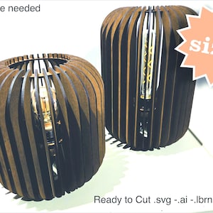 May include: Two wooden lampshades with a slatted design. The lampshades are brown and have a light bulb inside. The text "No glue needed" and "Ready to Cut .svg -.ai -.lbrn2-.dxf" is visible. The text "2 sizes" is in a pink starburst.