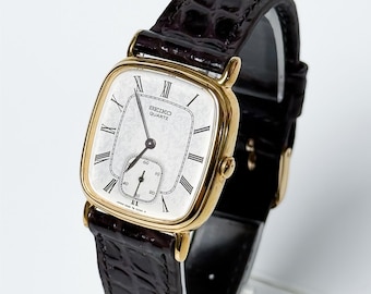 Reloj Seiko Quartz 2628-5000 de estilo clásico, con segundero pequeño y esfera blanca. El precio incluye envío, aranceles de importación e impuestos (DDP).