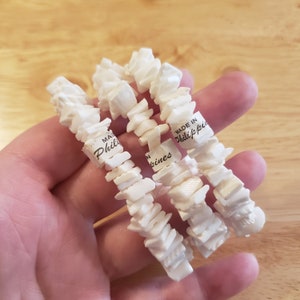 May include: Three white shell bracelets with the text "Made in Philippines" on the label.