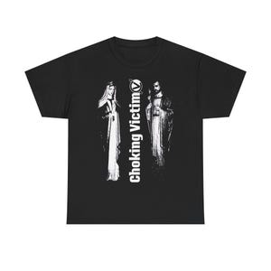 May include: Black t-shirt with a white graphic of two robed figures and the text "Choking Victim". The text is vertically aligned on the right side of the image.