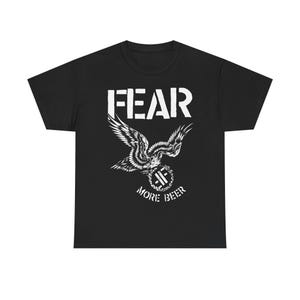 May include: Black t-shirt with a white graphic design. The design features the word "FEAR" above a stylized eagle with outstretched wings, and the words "MORE BEER" below.