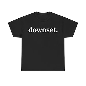 May include: Black t-shirt with the word "downset." printed in white, centered on the chest. The shirt has a crew neck and short sleeves. The fabric appears to be a soft, comfortable material.