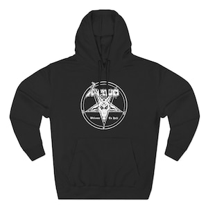 May include: Black hooded sweatshirt with a white graphic. The graphic features the word "Venom" above a pentagram with a goat head and the words "Welcome To Hell". The sweatshirt has a front pocket and a drawstring hood.