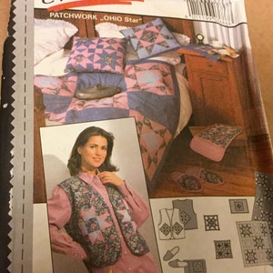 May include: A sewing pattern package featuring a patchwork design. The package shows a quilt, pillows, and a vest with a floral and geometric pattern in pink, blue, and white. The text "PATCHWORK OHIO Star" is visible.