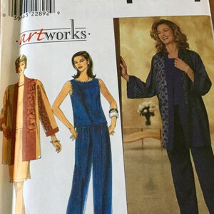 May include: Simplicity sewing pattern featuring women's clothing designs. The pattern includes illustrations of a jumpsuit, a jacket, and a top with pants. The color palette includes shades of blue, beige, and brown. The pattern is labeled with the "artworks" logo.