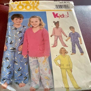 May include: A sewing pattern for children's pajamas. The pattern features illustrations of pajama sets in various colors and patterns, including cow and moon prints. The package has the text "NEW LOOK" and "Kids!"